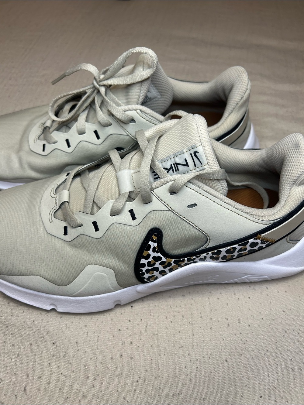 Nike Women's Cream Sneakers with Leopard Swoosh Accent